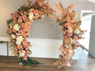 Gold & orange floral arbour. Floral backdrop . Wedding Ceremony.