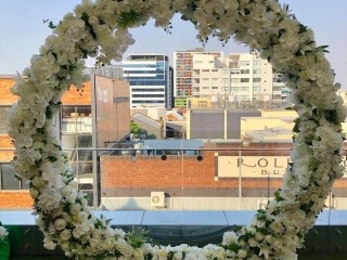 White floral Round arbour , Circle arch including flowers . Wedding decorations .