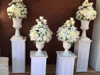 White flower with Roman vase + stand . Funeral , event , Wedding decorations .