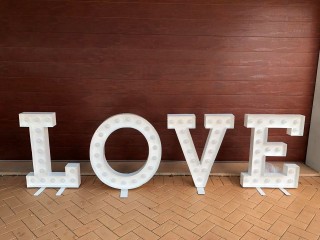 White Love letter sign with warm light . Wedding decorations .